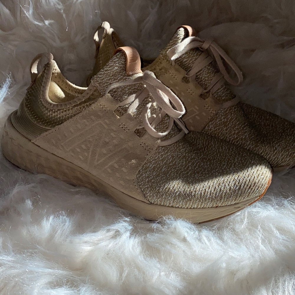 Gently used New Balance with suede like accent.